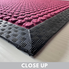 close up of red color front door mat